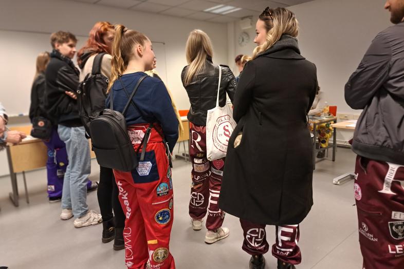 A group of students dressed in overalls.