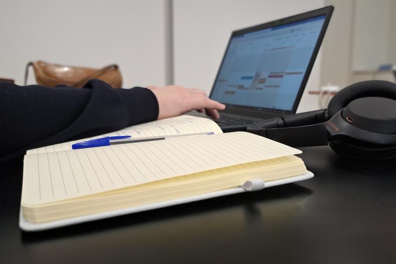 Notebook, headphones and a laptop.