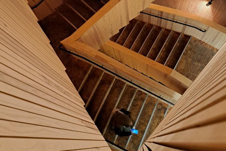 Opiskelija kulkee matkapuhelin kädessä Tiedekulman portaissa.