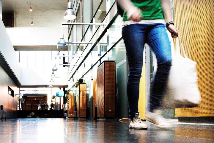 Opiskelija kävelee Physicumin käytävällä.